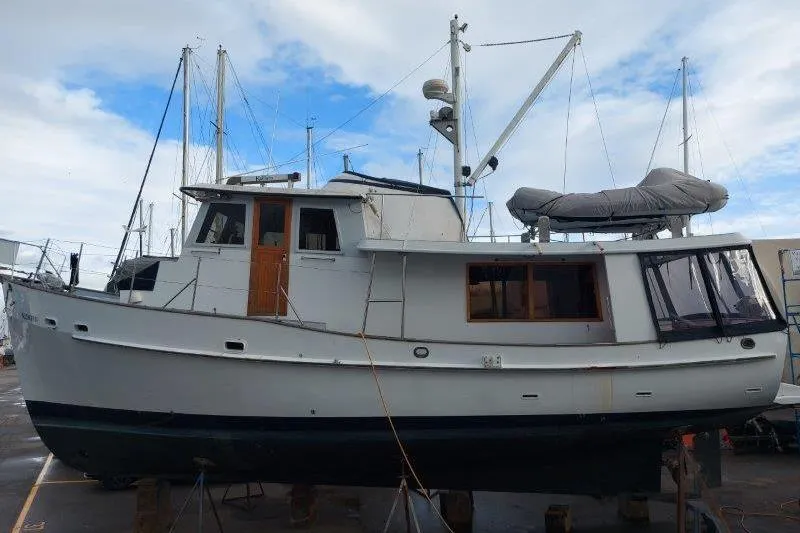 Kallisto Yacht Photos Pics 1982 Kadey-Krogen Pilothouse boat on dry dock, showcasing classic design and structure.