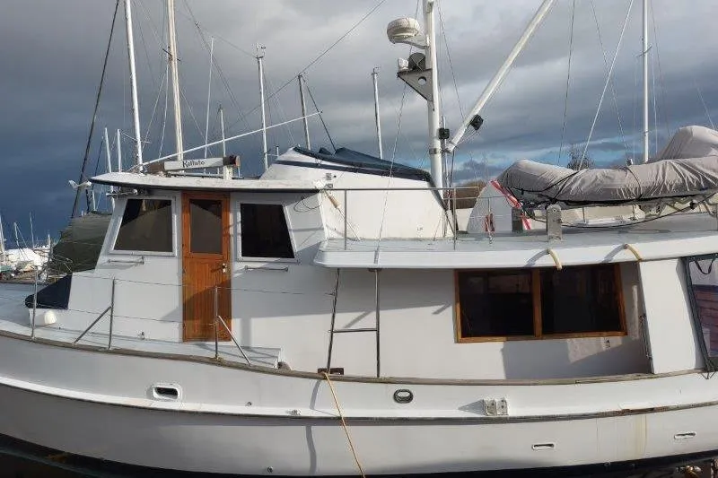 Kallisto Yacht Photos Pics 1982 Kadey-Krogen Pilothouse boat docked, featuring classic design and wooden accents.