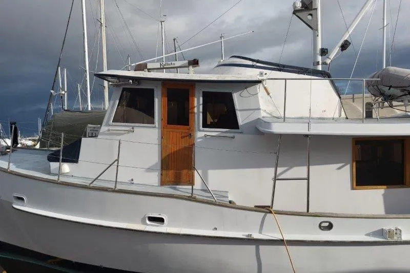 Kallisto Yacht Photos Pics 1982 Kadey-Krogen Pilothouse boat docked, featuring a classic design and wooden accents.