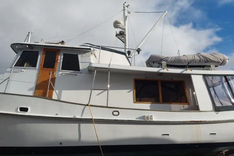 Kallisto Yacht Photos Pics 1982 Kadey-Krogen Pilothouse yacht with wooden accents and covered lifeboat.