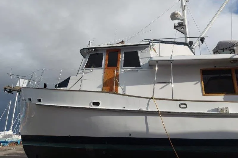 Kallisto Yacht Photos Pics 1982 Kadey-Krogen Pilothouse boat with wooden accents, docked under cloudy skies.