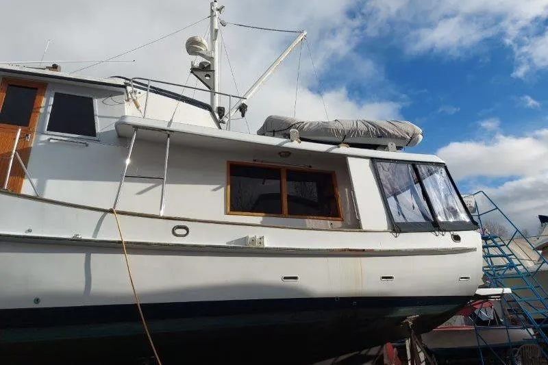 Kallisto Yacht Photos Pics 1982 Kadey-Krogen Pilothouse yacht docked under a partly cloudy sky.