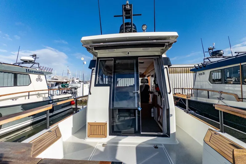  Yacht Photos Pics 2023 Targa 27.2 boat docked, showcasing rear deck and cabin entrance.