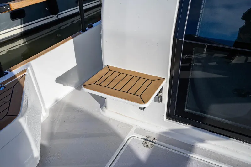 Yacht Photos Pics 2023 Targa 27.2 boat with wooden foldable seat and window view.