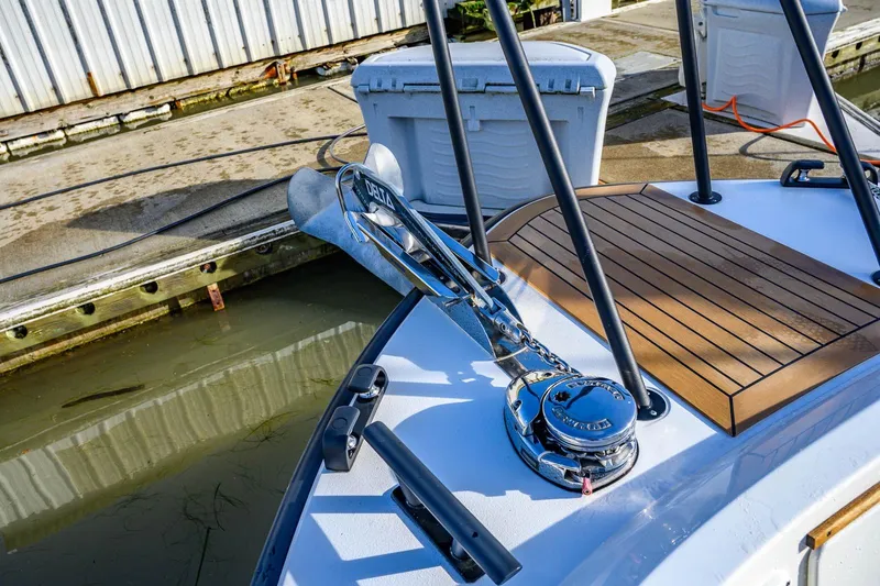  Yacht Photos Pics 2023 Targa 27.2 boat deck with anchor and wooden platform at dock.