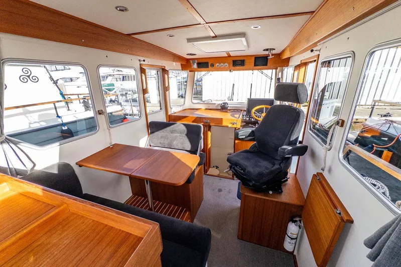  Yacht Photos Pics Interior of 2023 Targa 27.2 boat with wooden furnishings and seating.