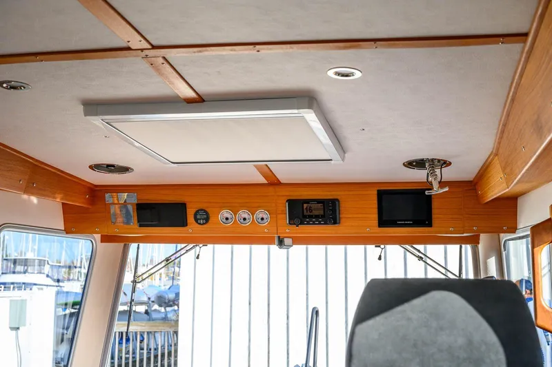  Yacht Photos Pics Interior of 2023 Targa 27.2 boat with control panel and wooden accents.