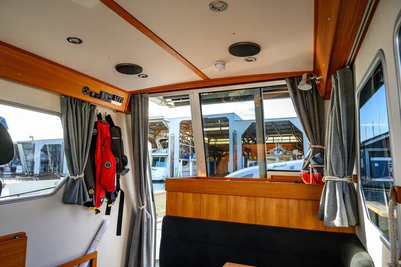  Yacht Photos Pics Interior of 2023 Targa 27.2 boat with wooden accents and dockside view.