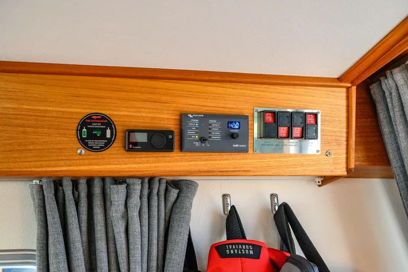  Yacht Photos Pics Control panel in 2023 Targa 27.2 boat with wooden finish and safety equipment.
