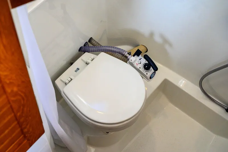  Yacht Photos Pics 2023 Targa 27.2 marine toilet with manual pump in compact bathroom setting.