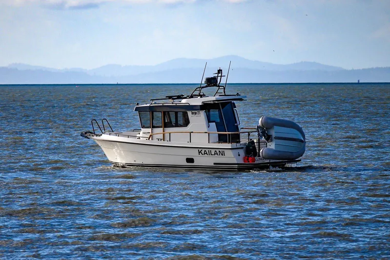  Yacht Photos Pics 2023 Targa 27.2 boat on open water with inflatable dinghy attached.