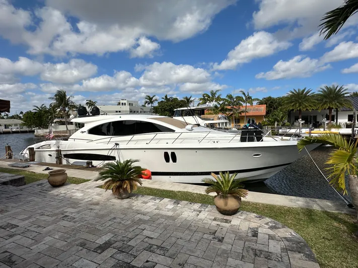 Volk Yacht Photos Pics 2009 Lazzara LSX 75 yacht docked by a scenic waterfront.