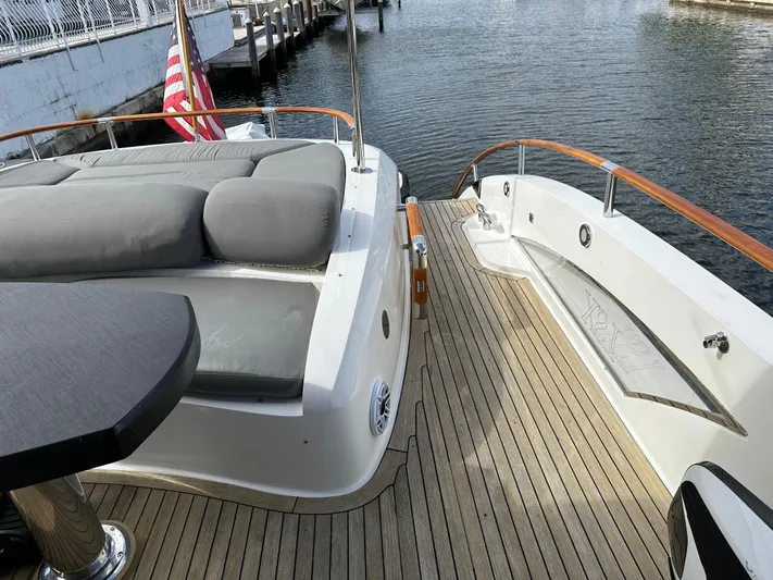 Volk Yacht Photos Pics 2009 Lazzara LSX 75 yacht deck with cushioned seating and wooden flooring.