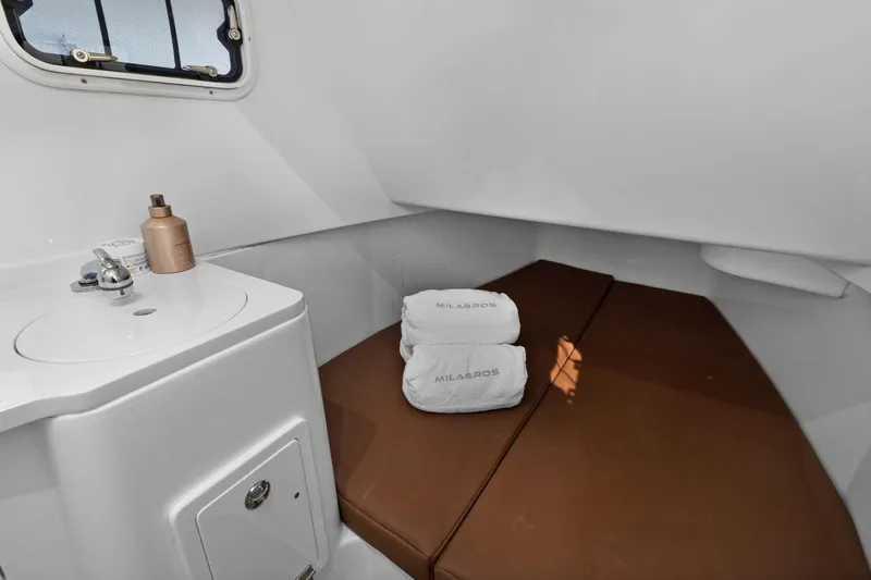  Yacht Photos Pics 2023 HCB Speciale cabin interior with sink, brown cushions, and folded towels.