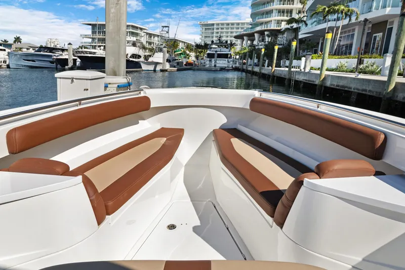  Yacht Photos Pics 2023 HCB Speciale boat interior with brown seating, docked in a marina.