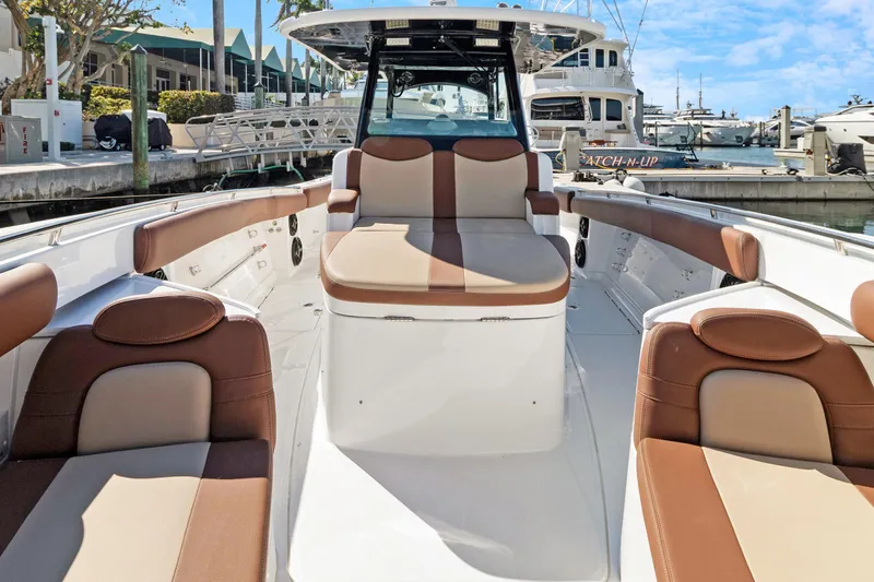  Yacht Photos Pics 2023 HCB Speciale boat interior with brown and beige seating at marina.