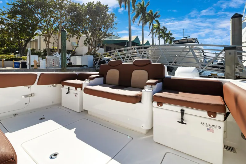  Yacht Photos Pics 2023 HCB Speciale boat interior with brown seating, docked at marina.