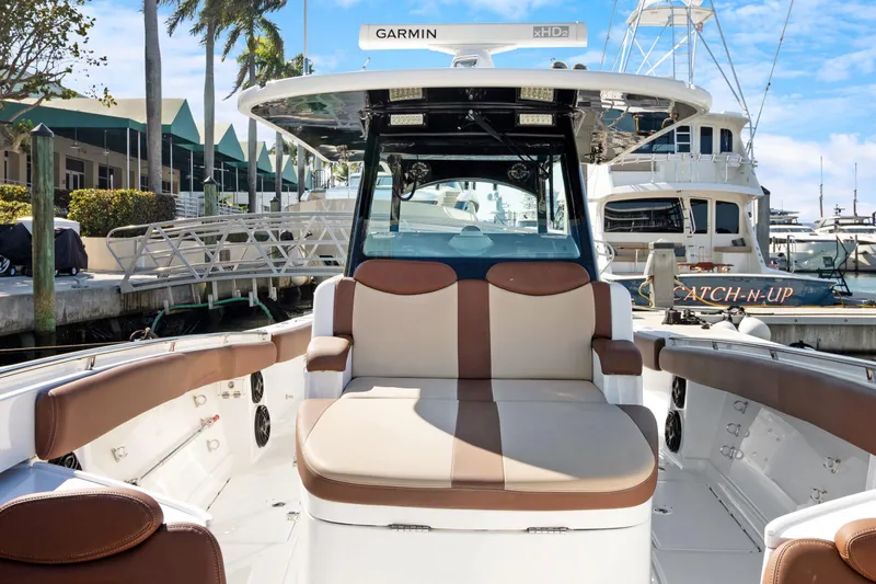  Yacht Photos Pics 2023 HCB Speciale boat interior with cushioned seating at a marina.