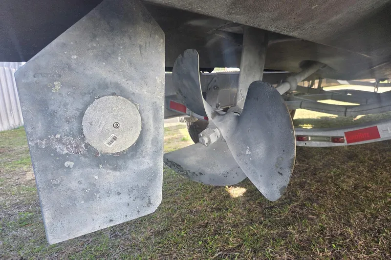 Smooth Operator Yacht Photos Pics Propeller and rudder of a 2008 True World Marine TE2810 boat on a trailer.