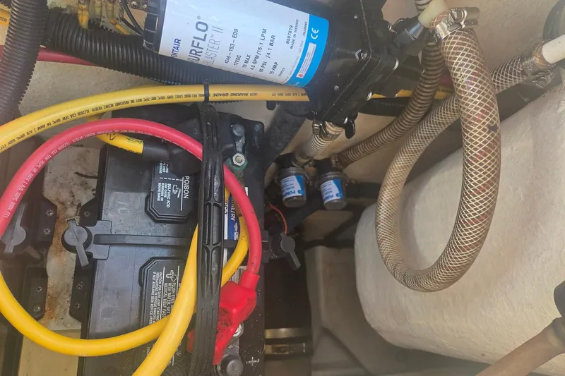 Smooth Operator Yacht Photos Pics 2008 True World Marine TE2810 engine compartment with battery, wiring, and pump system.