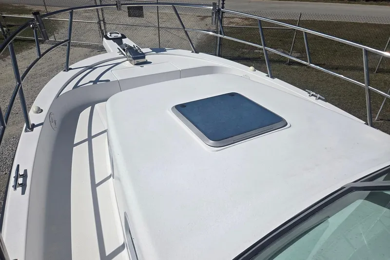 Smooth Operator Yacht Photos Pics 2008 True World Marine TE2810 boat deck with railing and hatch.