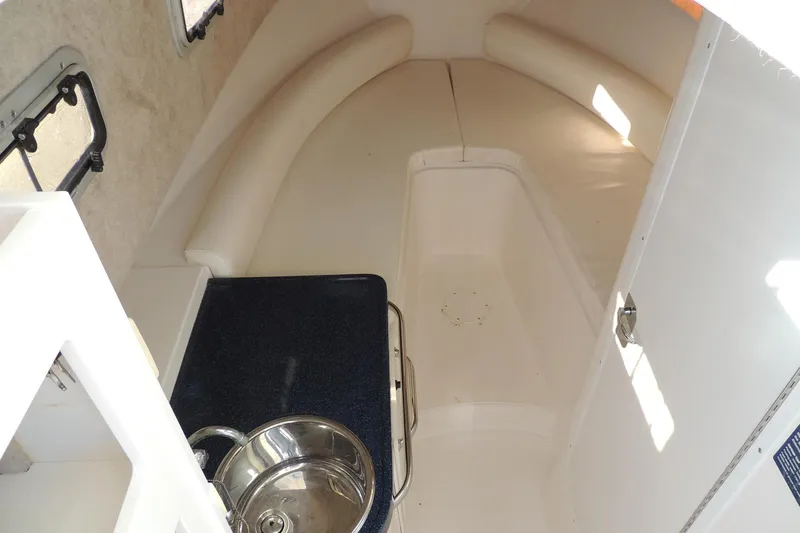 Smooth Operator Yacht Photos Pics 2008 True World Marine TE2810 cabin interior with sink and seating area.