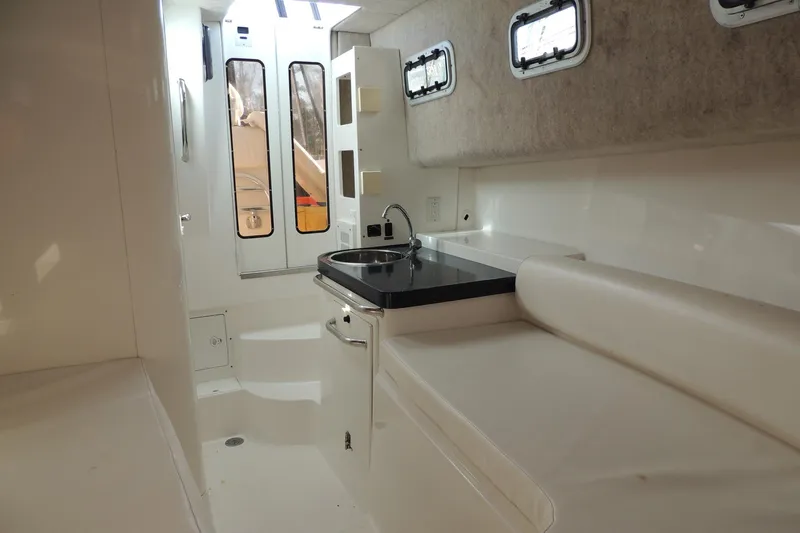 Smooth Operator Yacht Photos Pics Interior of 2008 True World Marine TE2810 boat with kitchenette and seating area.