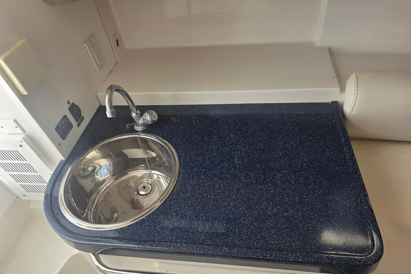 Smooth Operator Yacht Photos Pics 2008 True World Marine TE2810 boat interior with sink and countertop.