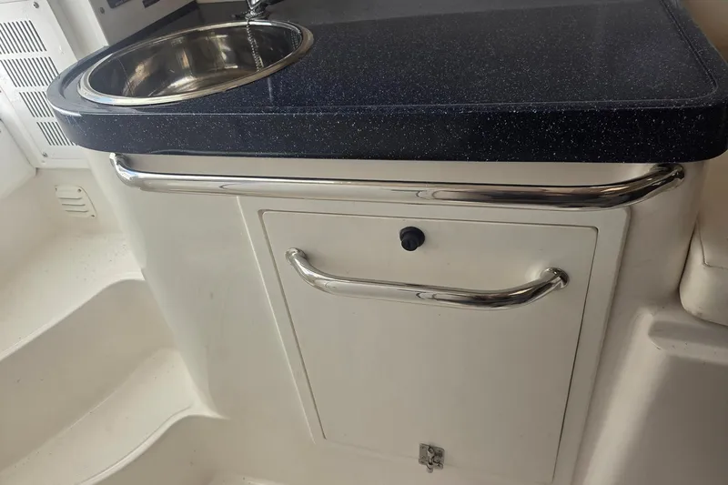 Smooth Operator Yacht Photos Pics 2008 True World Marine TE2810 boat sink and storage area with stainless steel fixtures.