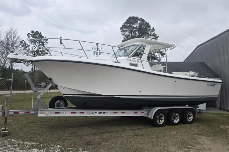 Smooth Operator Yacht Photos Pics 2008 True World Marine TE2810 boat on trailer, parked outdoors near a building.