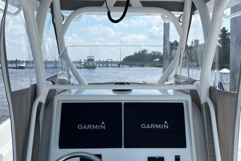 Lunasea Yacht Photos Pics 2023 Yellowfin 32 Offshore boat interior with Garmin navigation system, dock view.