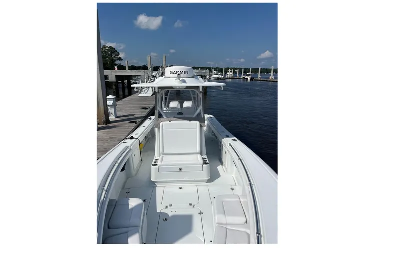 Lunasea Yacht Photos Pics 2023 Yellowfin 32 Offshore boat docked, featuring spacious deck and Garmin equipment.