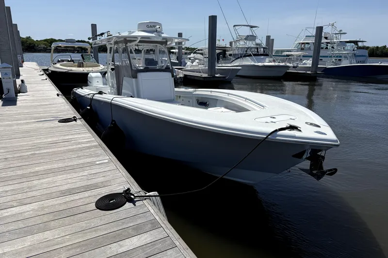 Lunasea Yacht Photos Pics 2023 Yellowfin 32 Offshore boat docked at marina, clear day.
