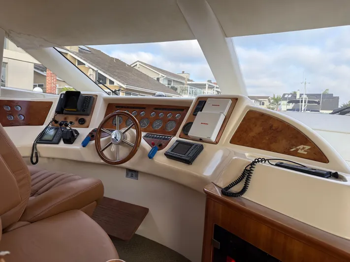 Miss Mazee Yacht Photos Pics Interior view of 1996 Azimut 54 yacht helm with steering wheel and navigation equipment.
