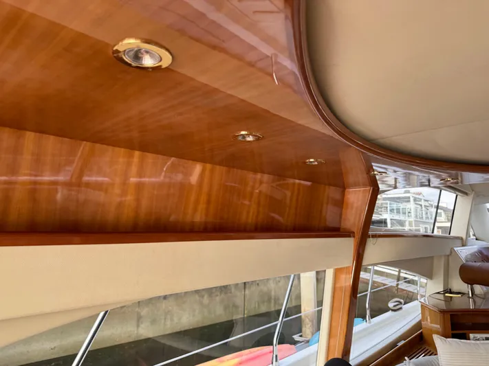Miss Mazee Yacht Photos Pics Interior of a 1996 Azimut 54 yacht with polished wood finish and recessed lighting.