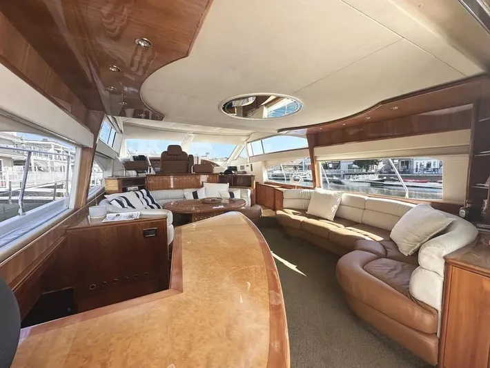 Miss Mazee Yacht Photos Pics Luxurious interior of a 1996 Azimut 54 yacht with elegant wood finishes and plush seating.