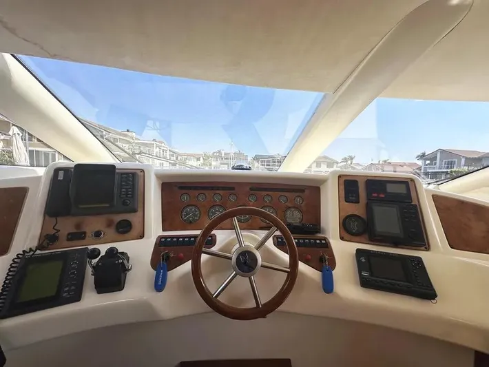 Miss Mazee Yacht Photos Pics Interior view of 1996 Azimut 54 yacht cockpit with steering wheel and navigation instruments.