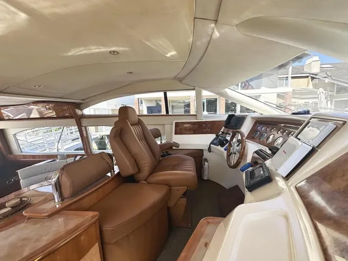 Miss Mazee Yacht Photos Pics Interior of a 1996 Azimut 54 yacht with luxurious leather seating and wooden dashboard.