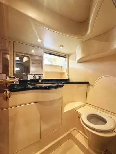 Miss Mazee Yacht Photos Pics Luxurious bathroom in a 1996 Azimut 54 yacht, featuring elegant fixtures and lighting.