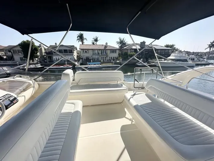 Miss Mazee Yacht Photos Pics Luxurious 1996 Azimut 54 yacht interior with white seating and waterfront view.