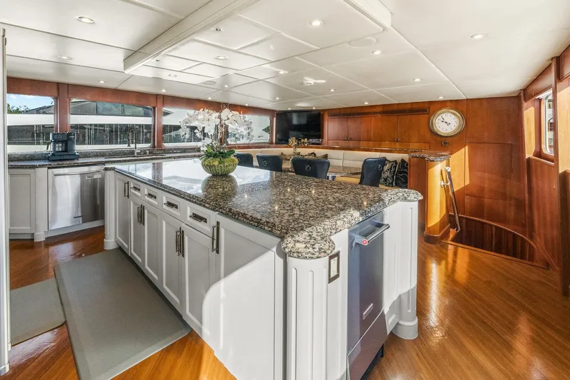  Yacht Photos Pics Luxurious 1999 Trinity Yachts Raised Pilothouse interior with elegant kitchen and seating area.