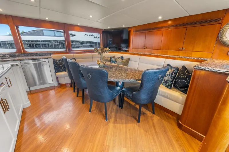  Yacht Photos Pics Luxurious interior of 1999 Trinity Yachts Raised Pilothouse with elegant dining area and modern decor.