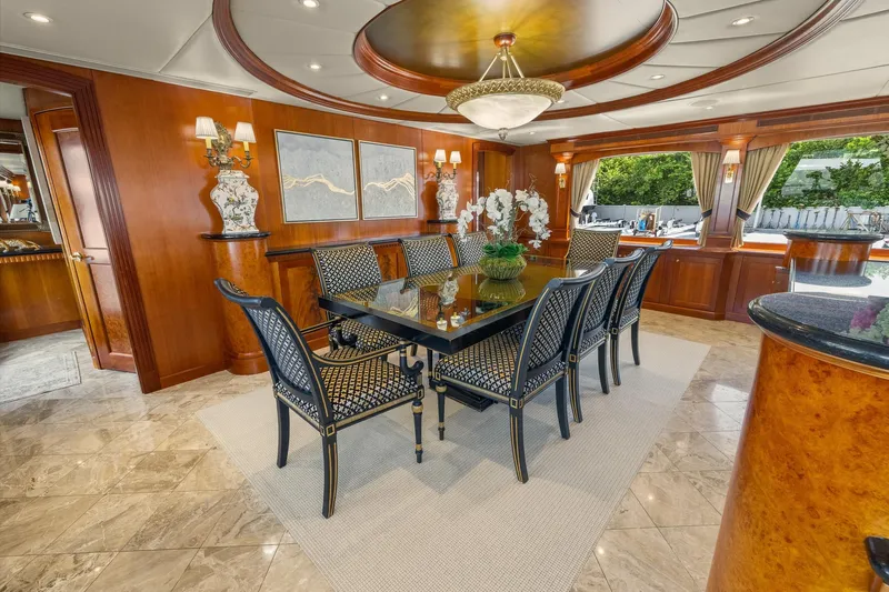  Yacht Photos Pics Luxurious dining area on 1999 Trinity Yachts Raised Pilothouse, featuring elegant decor and seating.