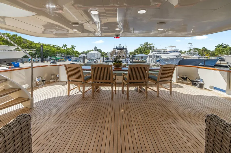  Yacht Photos Pics Luxurious 1999 Trinity Yachts Raised Pilothouse with elegant outdoor seating and marina view.