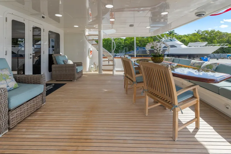  Yacht Photos Pics Luxurious 1999 Trinity Yachts Raised Pilothouse deck with elegant seating and dining area.