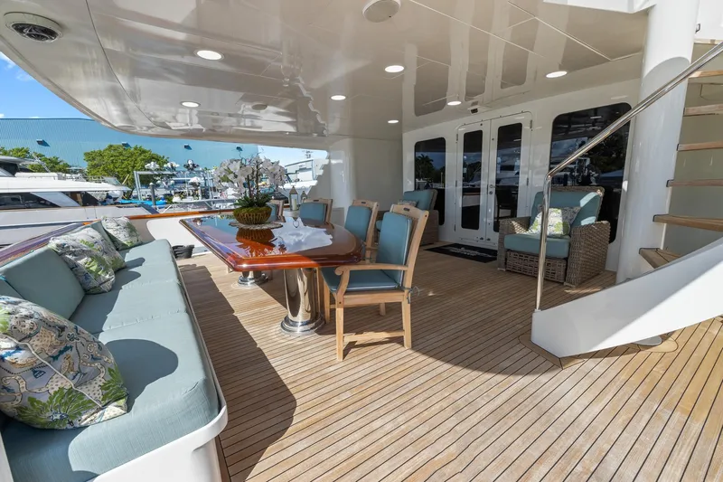  Yacht Photos Pics Luxurious 1999 Trinity Yachts Raised Pilothouse deck with elegant seating and dining area.