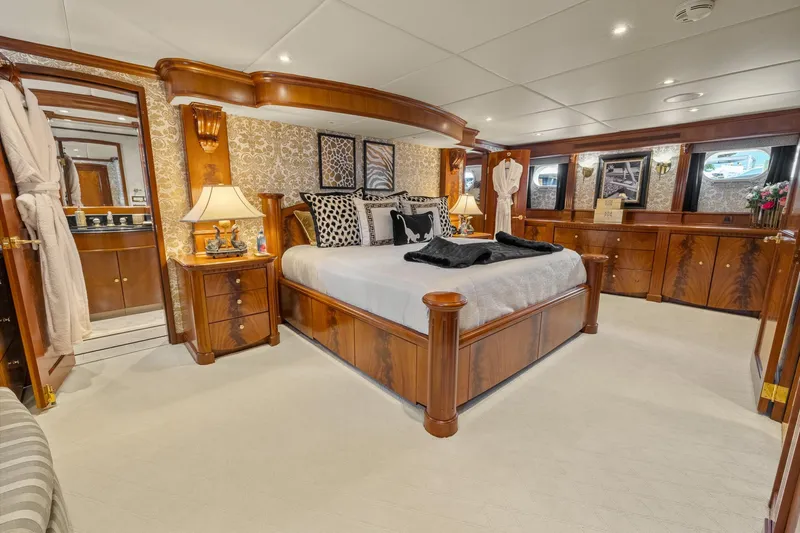  Yacht Photos Pics Luxurious 1999 Trinity Yachts Raised Pilothouse bedroom with elegant wood furnishings.