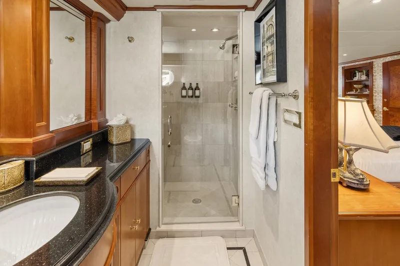  Yacht Photos Pics Luxurious bathroom on 1999 Trinity Yachts Raised Pilothouse, featuring elegant wood and marble finishes.