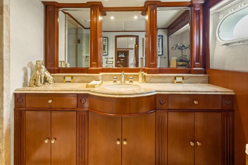  Yacht Photos Pics Luxurious wooden vanity in 1999 Trinity Yachts Raised Pilothouse bathroom, featuring elegant decor.