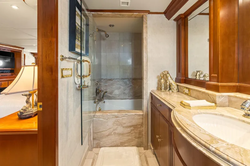  Yacht Photos Pics Luxurious bathroom in 1999 Trinity Yachts Raised Pilothouse, featuring elegant wood and marble finishes.